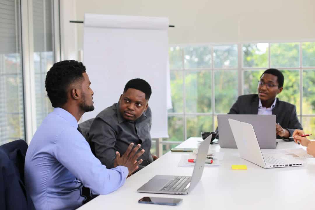 Professional business mentorship session with entrepreneurs receiving guidance and training in modern conference room environment
