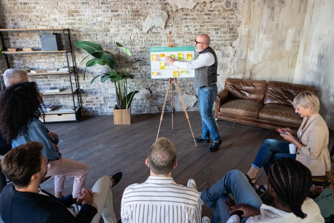 Community Stakeholder Meeting and Development Strategy Discussion Senior business professional discussing development project strategy with community stakeholders and team members