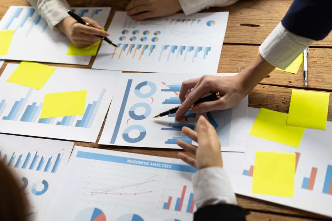 Business strategy documents and competitive analysis charts showing market positioning research for economic development site selection strategies
