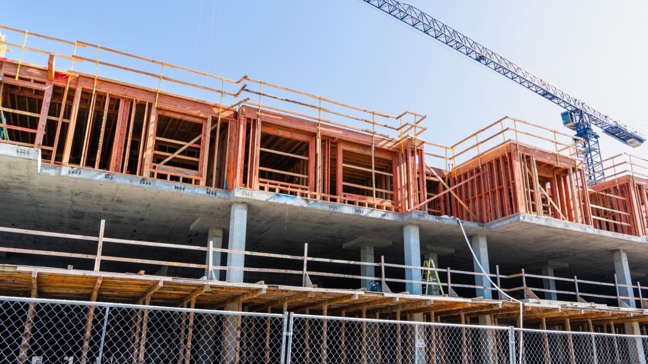 Construction site management and building development showing project implementation and quality control for mixed-use development