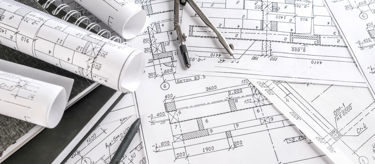 Engineering blueprints and project planning documents showing technical design and planning processes for infrastructure development projects
