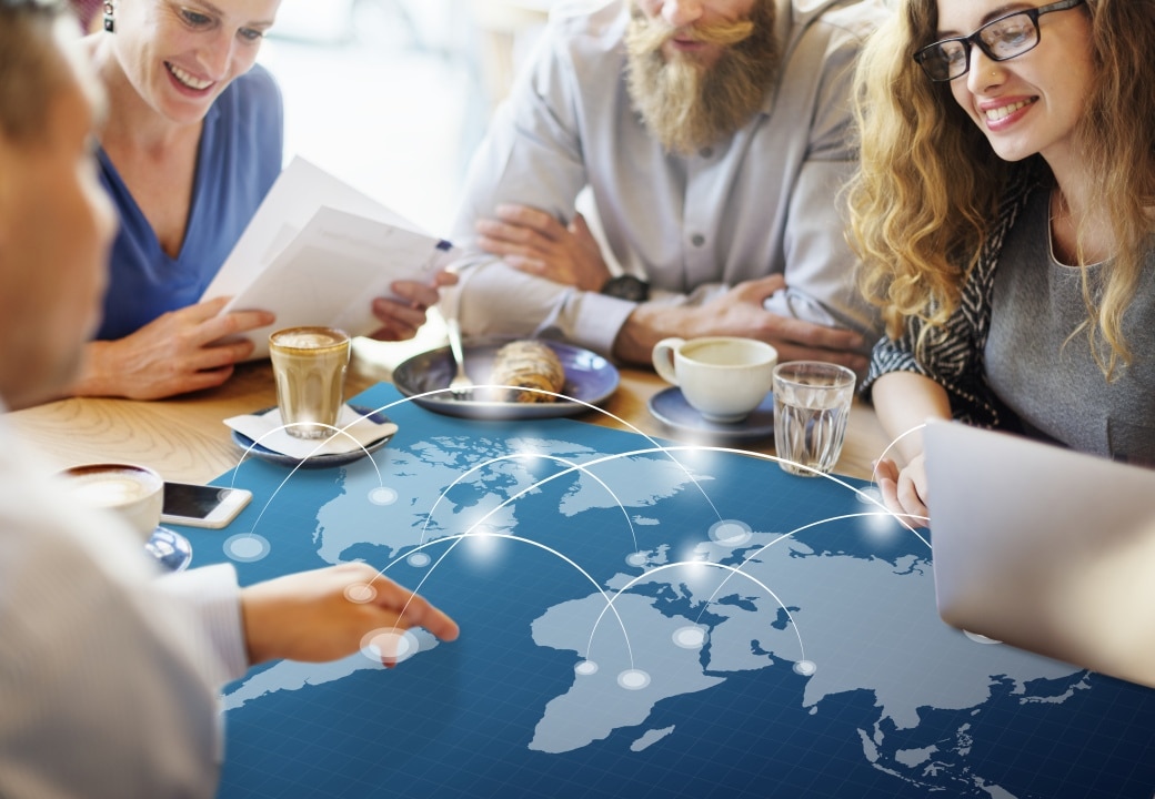  Business professionals discussing international EB-5 immigration investment opportunities using world map for regional development planning