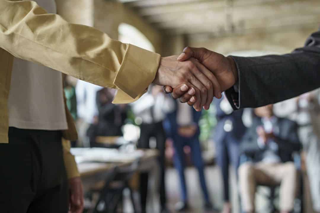 Professional networking event showing business leaders and entrepreneurs building partnerships and community connections for economic development