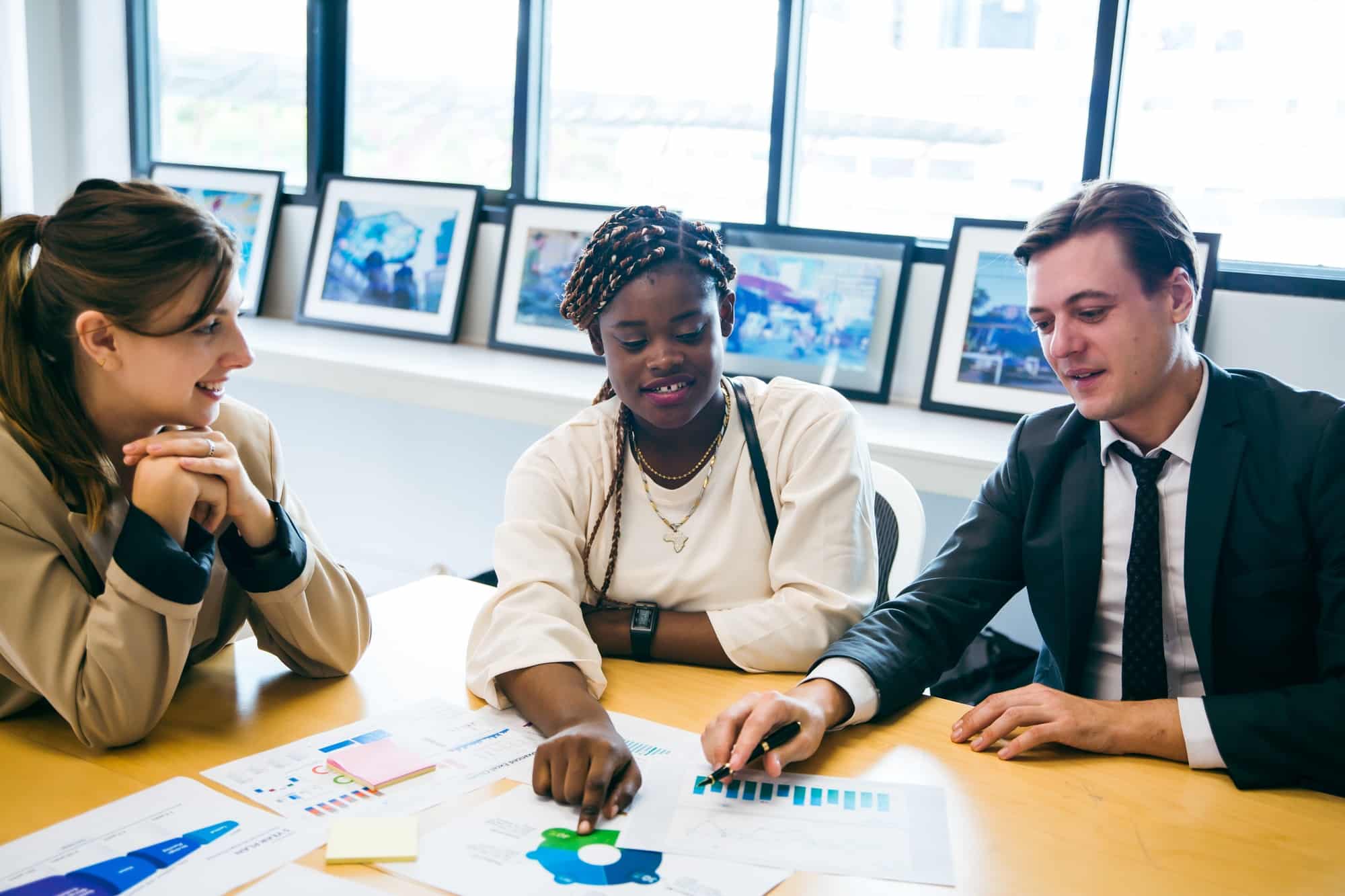 Business professionals reviewing regional economic development statistics and collaboration strategies in team meeting