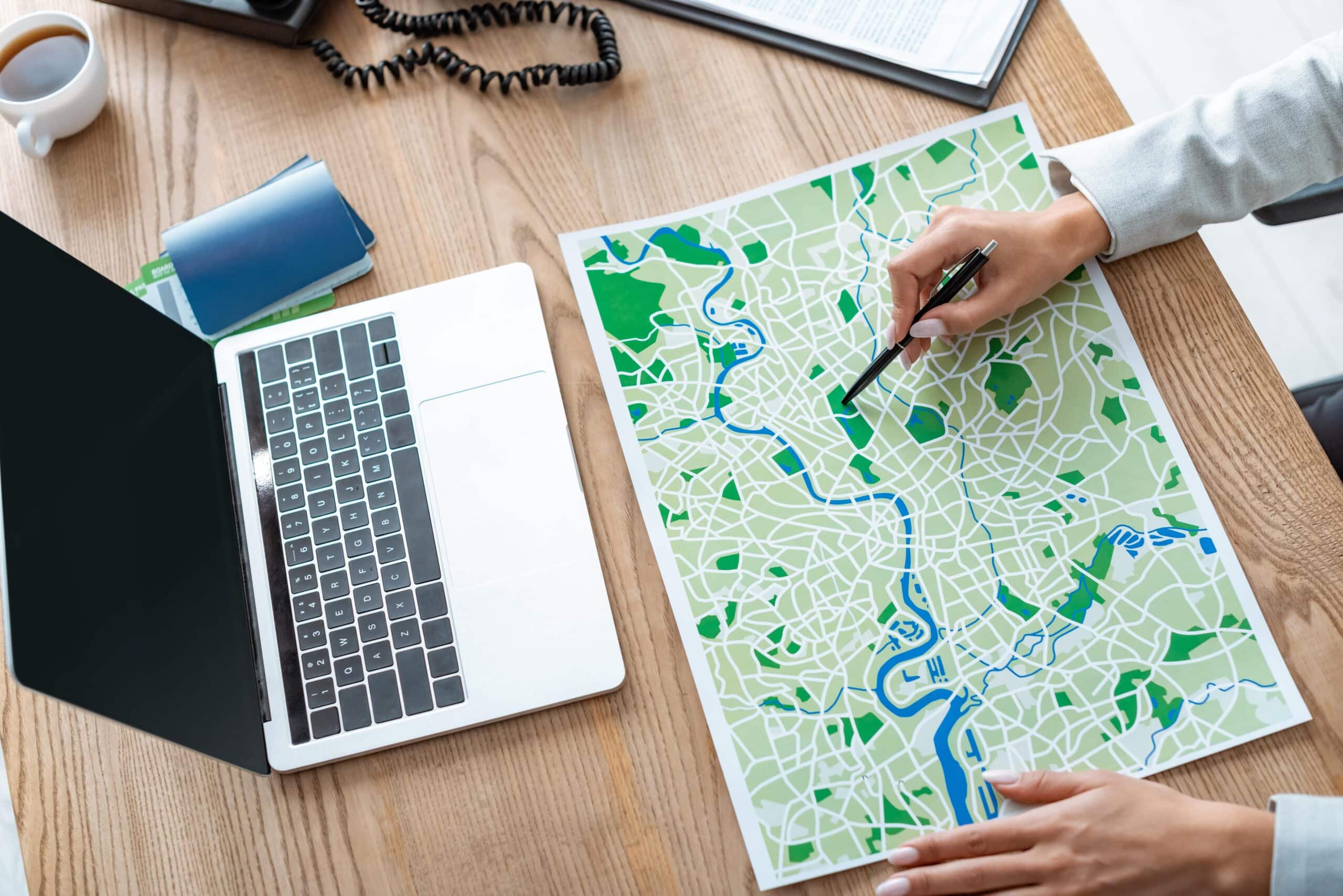 Business location analysis with maps and planning documents representing corporate site selection decision-making processes for economic development